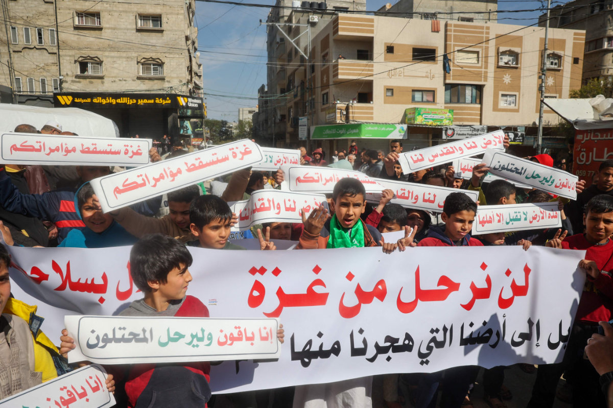 Palestinians protest at the Nuseirat camp in the central Gaza Strip on February 14, 2025, against US president Trump's proposal for the US to take over the Gaza Strip and to move more than two million Palestinians out of the territory. (AFP)