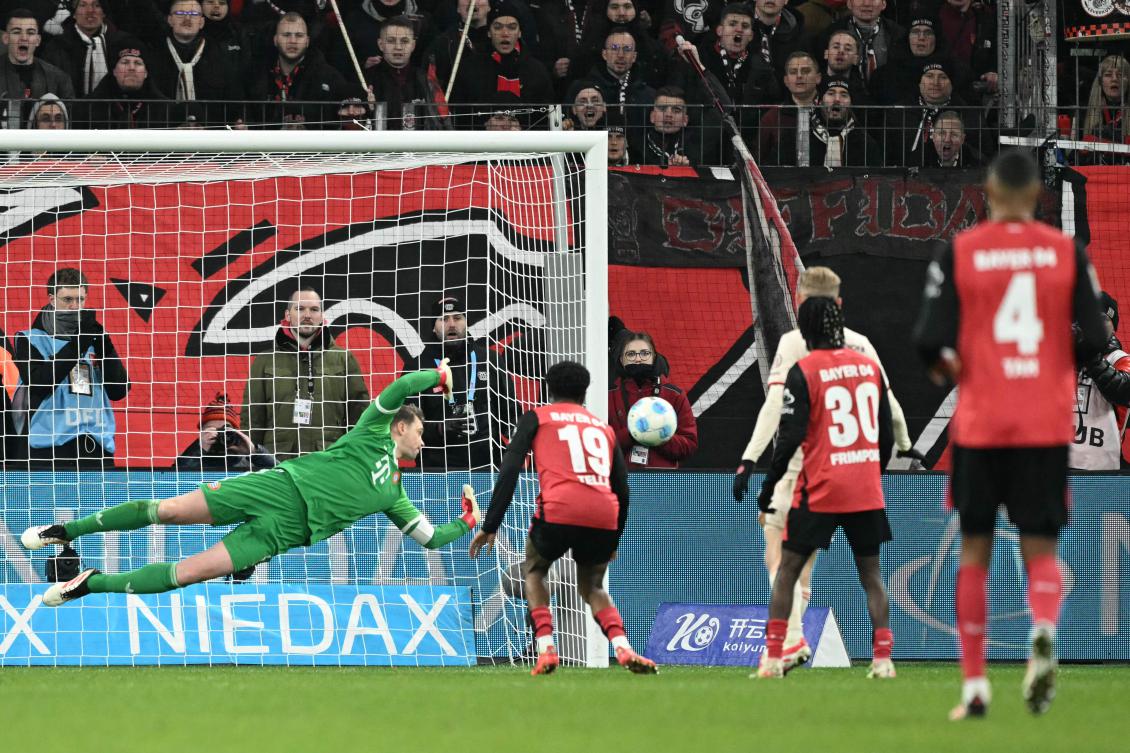 Bayern Munich’s German goalkeeper Manuel Neuer dives for the ball during their Bundesliga match against Bayer 04 Leverkusen in Leverkusen, on Feb. 15, 2025. (AFP)