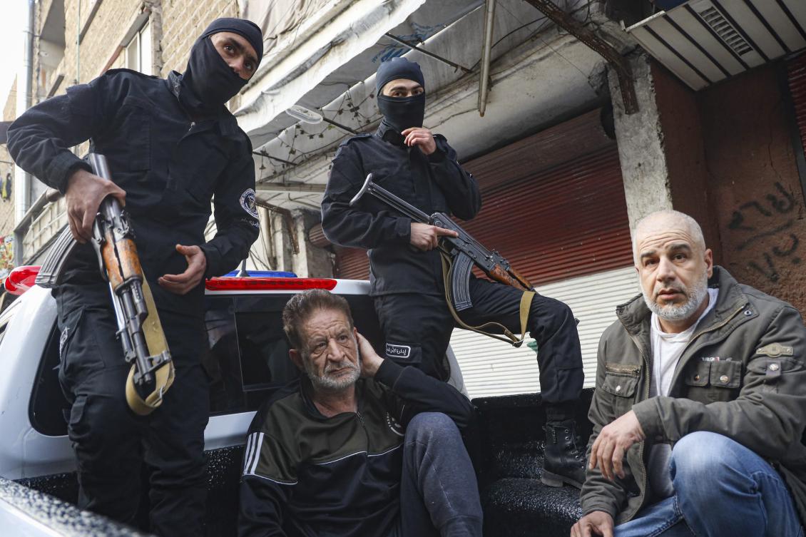 Imad Mohammed Al-Mahmoud, center left, and Somer Mohammed Al-Mahmoud,(R), alleged former operatives with military security before the fall of Assad, are arrested in Tadamon, a Damascus suburb, Syria, on Feb. 17, 2025. (AP)
