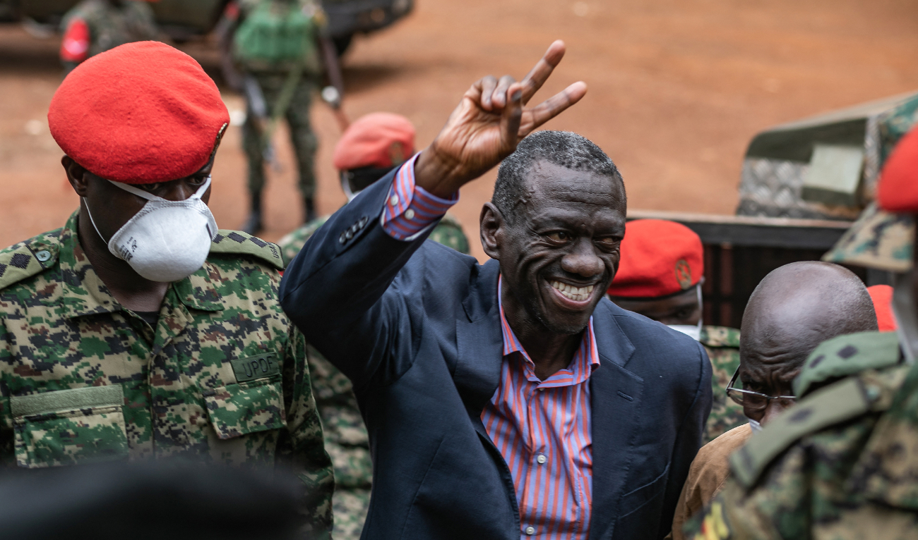 Uganda's veteran opposition figure Kizza Besigye gestures as he arrives at the Makindye Martial Court in Kampala, on November 20, 2024. (AFP/File)
