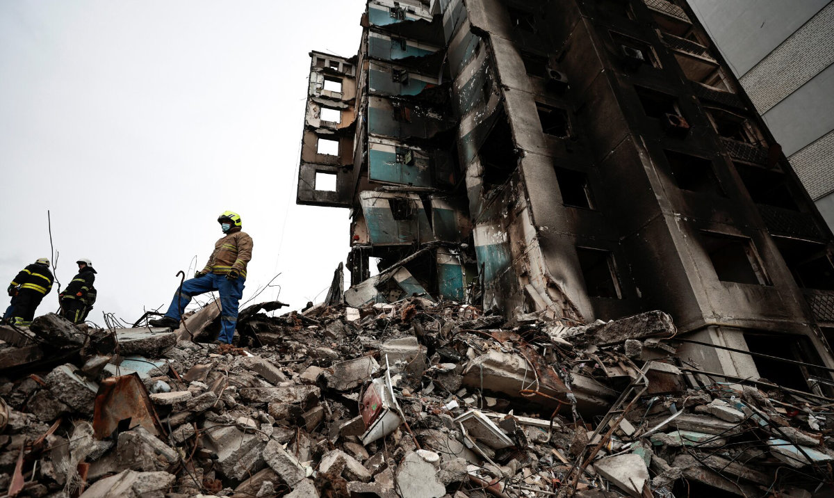 A rescuer stands on the rubble of a building destroyed by Russian shelling, as they start searching for bodies, amid Russia's Invasion of Ukraine, in Borodyanka, Kyiv region, Ukraine. (Reuters/File)