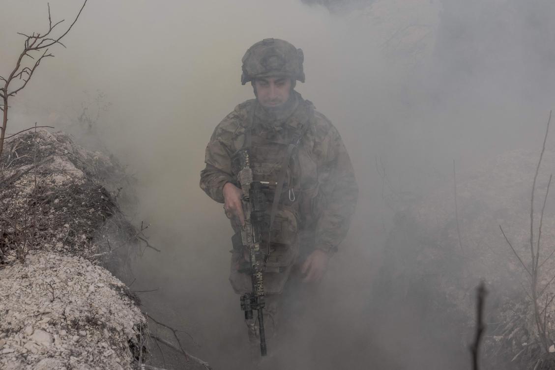 A Ukrainian military instructor of the Azov Brigade walks through a trench during a military training exercise in the eastern Donetsk region, on February 3, 2025, amid the Russian invasion of Ukraine. (AFP)