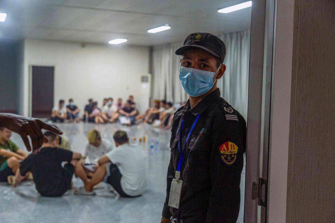 A security guard stands guard next to a room full of alleged scam center workers and victims during a crackdown on illicit activity in Shwe Kokko in Myanmar’s eastern Myawaddy township on Feb. 14, 2025. (AFP)
