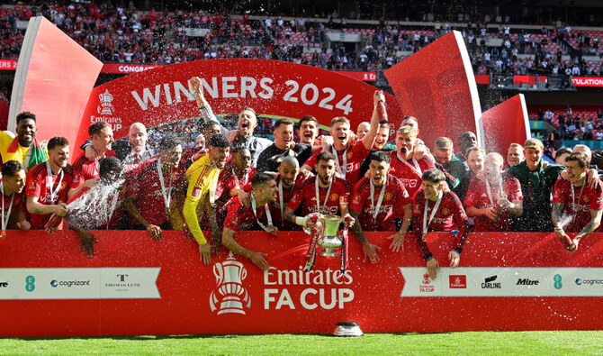Man United’s Portuguese midfielder Bruno Fernandes lifts the trophy to celebrate their victory at the end of the English FA Cup final between Man City and Man United at Wembley stadium, on May 25, 2024. (AFP/File)