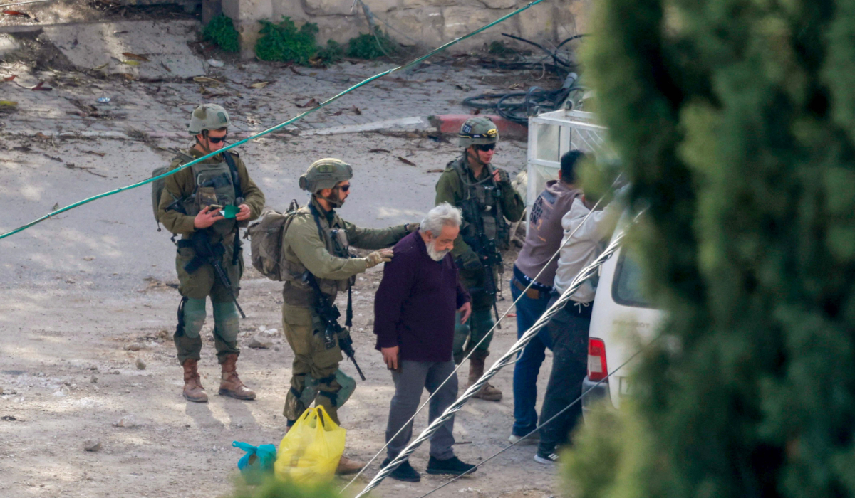 Israeli soldiers detain a man in the Tulkarem camp for Palestinian refugees during an ongoing Israeli military operation in the occupied West Bank on February 18, 2025. (AFP)