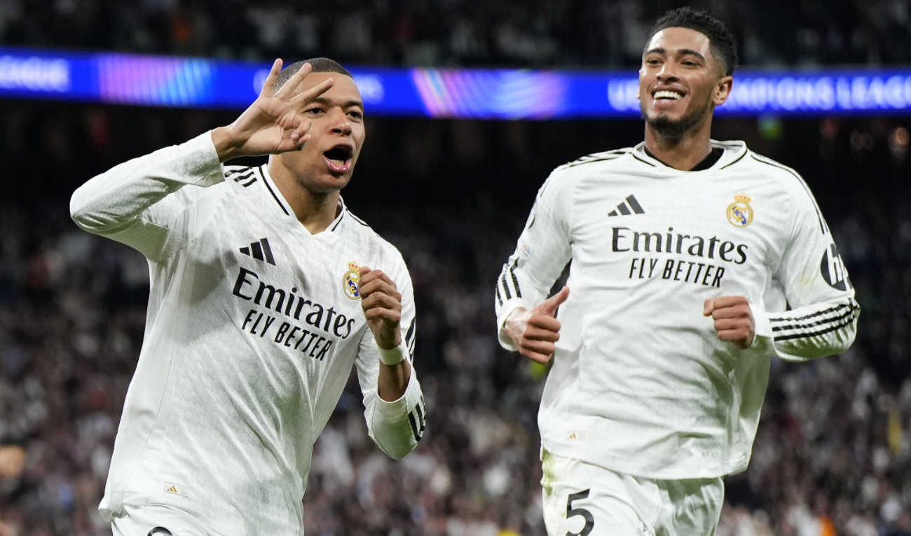 Real Madrid's Kylian Mbappe celebrates with Real Madrid's Jude Bellingham, right, after scoring his sides third goal during the Champions League playoff second leg soccer match between Real Madrid and Manchester City at the Santiago Bernabeu Stadium in Madrid, Spain, Wednesday, Feb. 19, 2025. (AP)