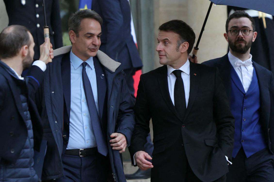 French President Emmanuel Macron escorts Greece's Prime Minister Kyriakos Mitsotakis after a meeting, as part of the Artificial Intelligence (AI) Action Summit, at the Elysee Palace, in Paris, on February 10, 2025. (AFP)