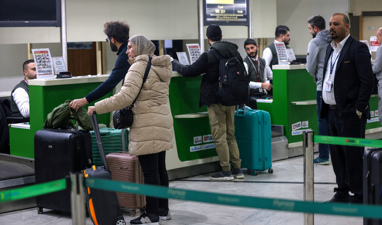 People line up to check in for a flight to Beirut at the Baghdad International Airport. Flights are nearly at capacity as airlines increase services. (AFP)