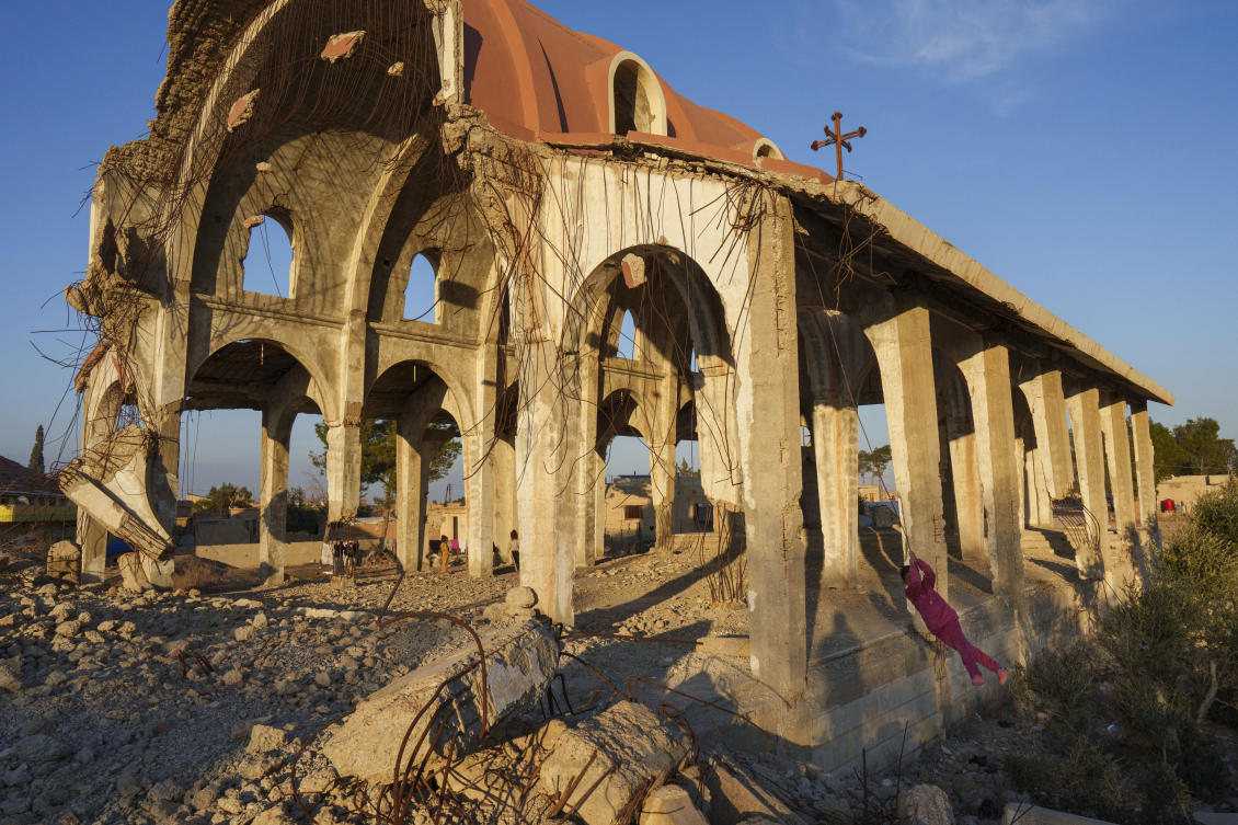 Children play in the ruins of the Church of Virgin Mary, which was destroyed by the Daesh group in 2015, in the northeastern Syrian village of Tel Nasri, which is currently controlled by the US-backed, Kurdish-led Syrian Democratic Forces, Monday, Jan. 27, 2025. (AP)