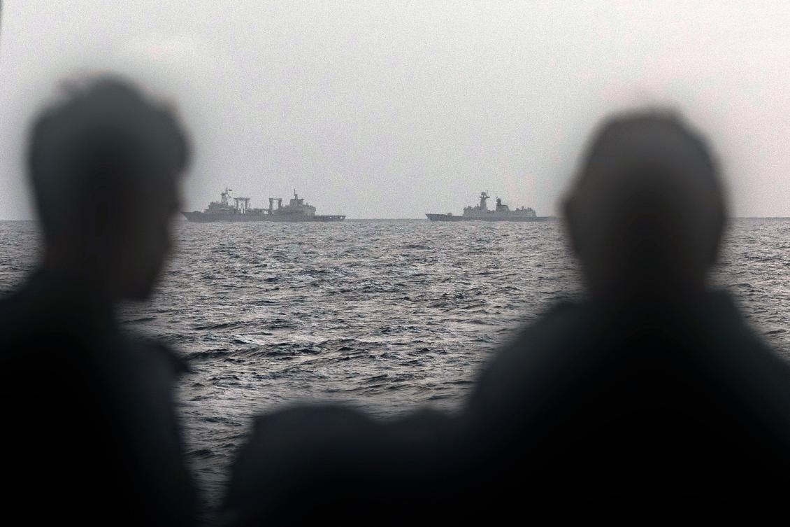 Australian sailors onboard the ship HMAS Arunta look at the Chinese Fuchi-class replenishment vessel and Weishanhu Jiangkai-class frigate Hengyang in the Tasman Sea on Feb. 13, 2025. (Australian Defence Force /AFP)