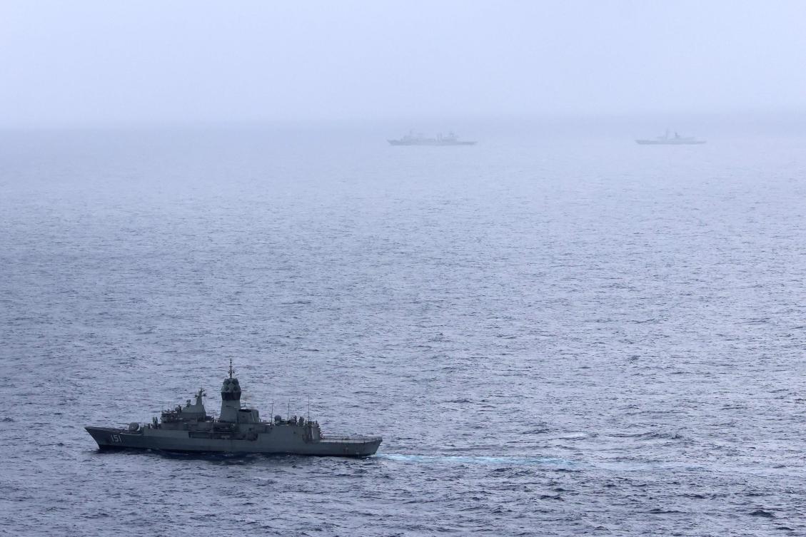 Above, the Australian navy ship HMAS Arunta, lower left, sails near the Chinese Fuchi-class replenishment vessel and Weishanhu Jiangkai-class frigate Hengyang in the Tasman Sea on Feb. 13, 2025. (Australian Defence Force/AFP)