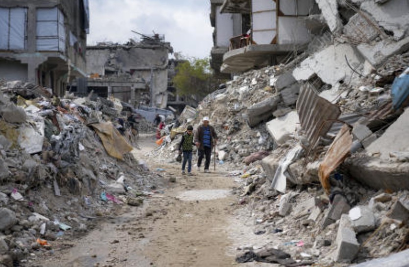 People walk amid the rubble of homes destroyed by the Israeli army’s air and ground offensive against Hamas in Jabaliya, northern Gaza Strip on Feb. 19, 2025. (AP)