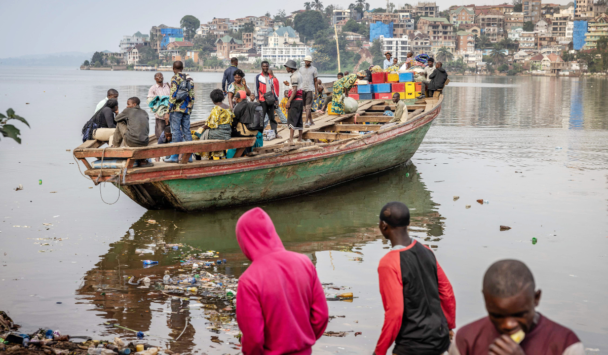 Families sail in a boat as it departs for Minova from a pirogue dock on the shores of Lake Kivu in Bukavu on February 21, 2025, as around 42,000 people have fled the conflict raging in eastern Democratic Republic of Congo and crossed into Burundi in the past two weeks, the United Nations said today. (AFP)