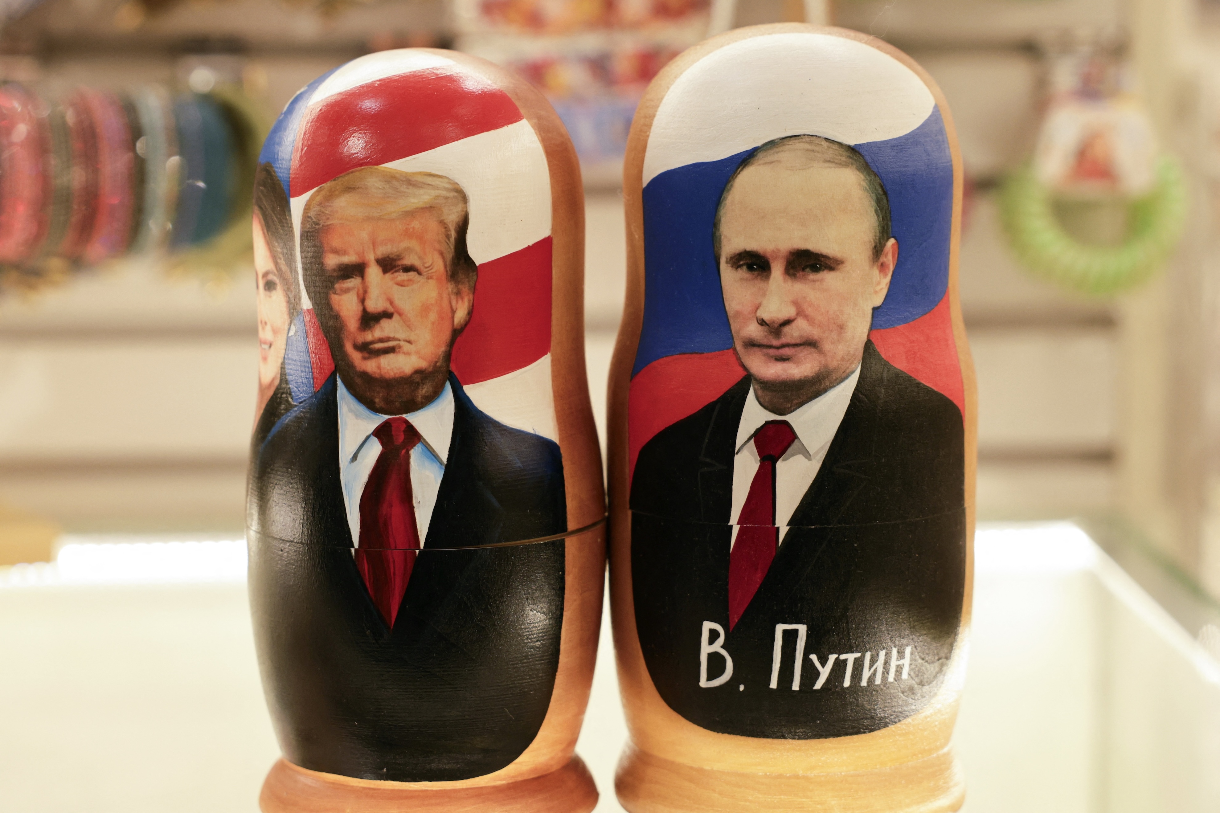 Traditional Russian wooden nesting dolls depicting Russia's President Vladimir Putin and US President Donald Trump are displayed at a gift shop in Moscow, Feb. 13, 2025. (AFP)