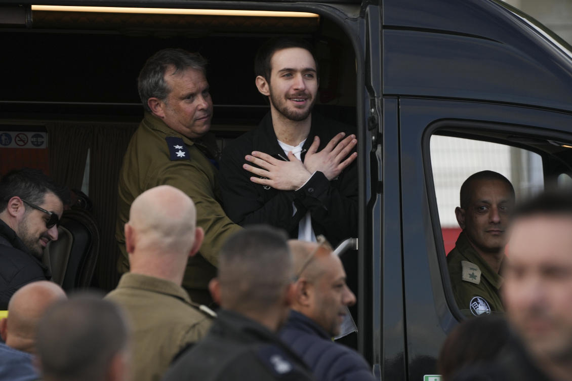 Freed Israeli hostage Omer Shem Tov gestures from a van as he arrives at Beilinson hospital in Petah Tikva, Israel, after he was released from Hamas captivity in the Gaza Strip, Saturday, Feb. 22, 2025. (AP)