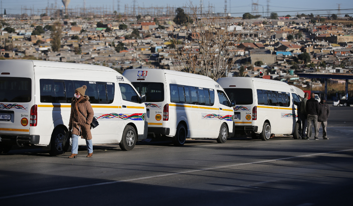 A pedestrian walks past as taxi operators in Tembisa north of Johannesburg on July 14, 2021. (AFP)