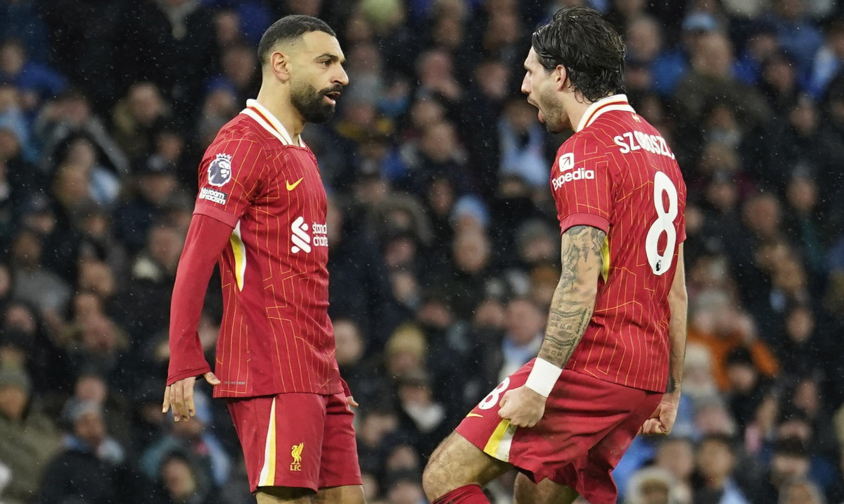 Liverpool's Dominik Szoboszlai, right, celebrates with Mohamed Salah scoring his side's 2nd goal during the English Premier League soccer match between Manchester City and Liverpool at Etihad stadium in Manchester, England, Sunday, Feb. 23, 2025. (AP)