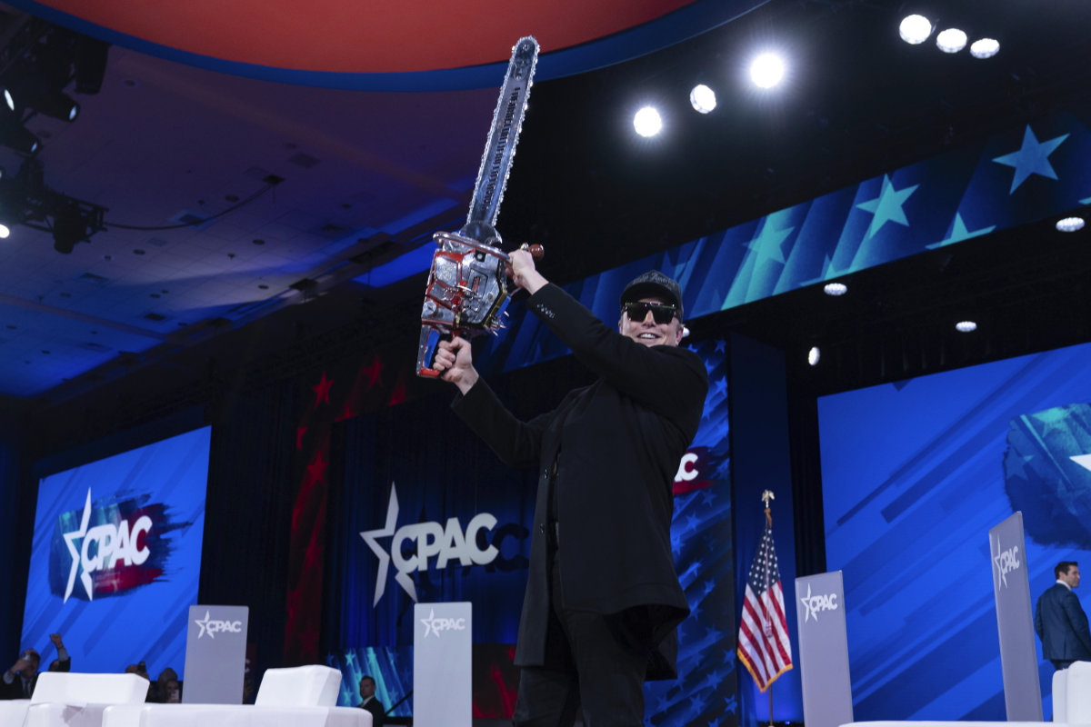 Elon Musk shows off with a chainsaw as he speaks at the Conservative Political Action Conference, CPAC, in Oxon Hill, Maryland, on Feb. 20, 2025. The chainsaw was a gift from Argentine President Javier Milei, who used the power tool to symbolize his proposals to shred the bloated state bureaucracy. (AP Photo)