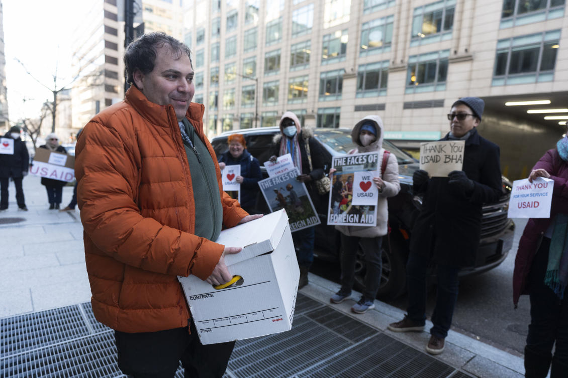 A United States Agency for International Development worker carries personal belongings after retrieving them from the USAID’s Bureau of Humanitarian Affairs office in Washington on Feb. 21, 2025. (AP)