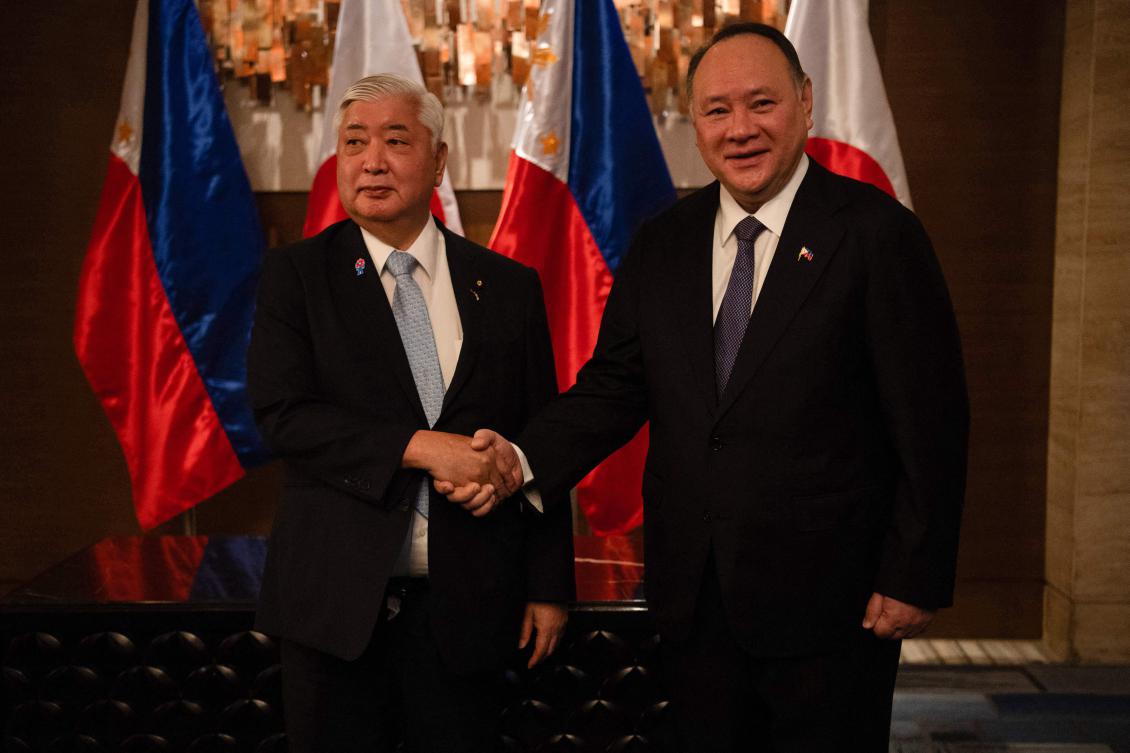 Philippines’ Secretary of National Defense Gilberto Teodoro, right, shakes hands with his Japanese counterpart Gen Nakatani prior to their meeting in Manila on Feb. 24, 2025. (AFP)
