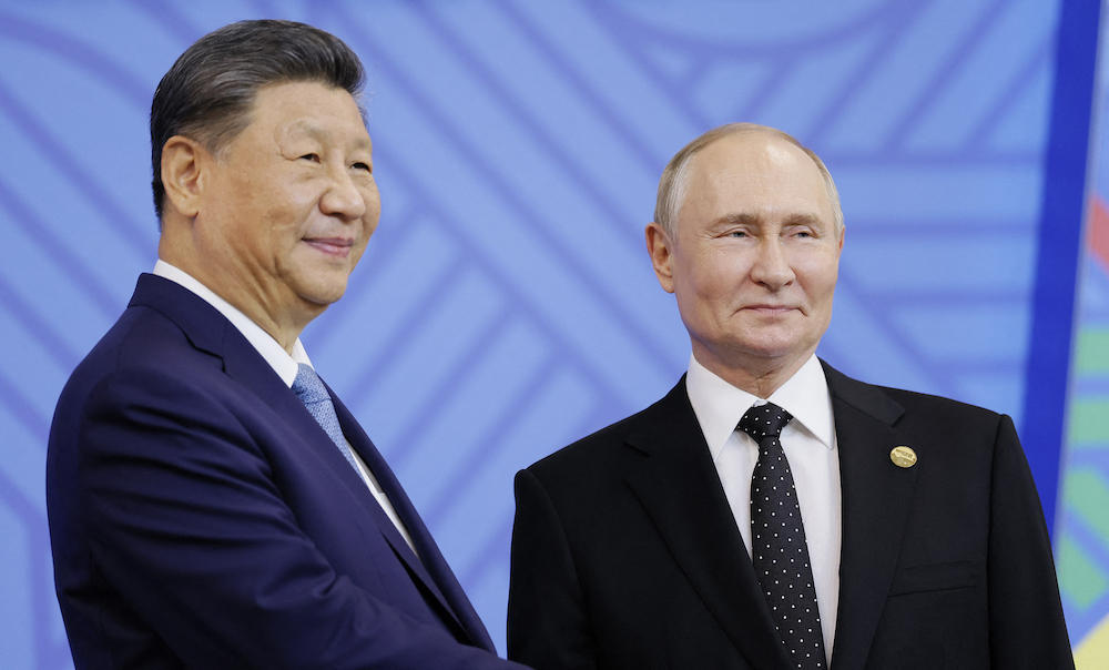 Above, Russian President Vladimir Putin greets Chinese President Xi Jinping during an official welcoming ceremony for delegation heads at the BRICS summit in Kazan on Oct. 23, 2024. (AFP file photo)