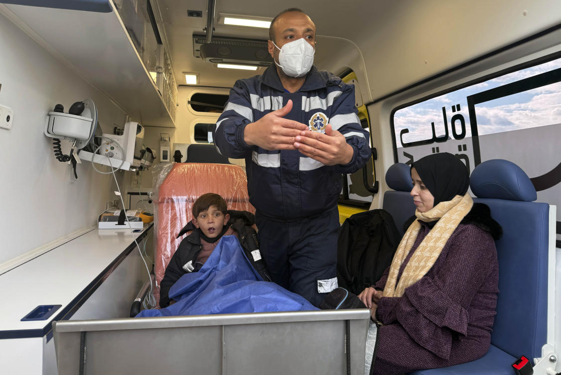 Palestinian Yazan El-Masry, who is in need to have an open-heart surgery, is accompanied by his mother at an ambulance at the Rafah border crossing in Egypt on Feb. 24, 2025. (AP)