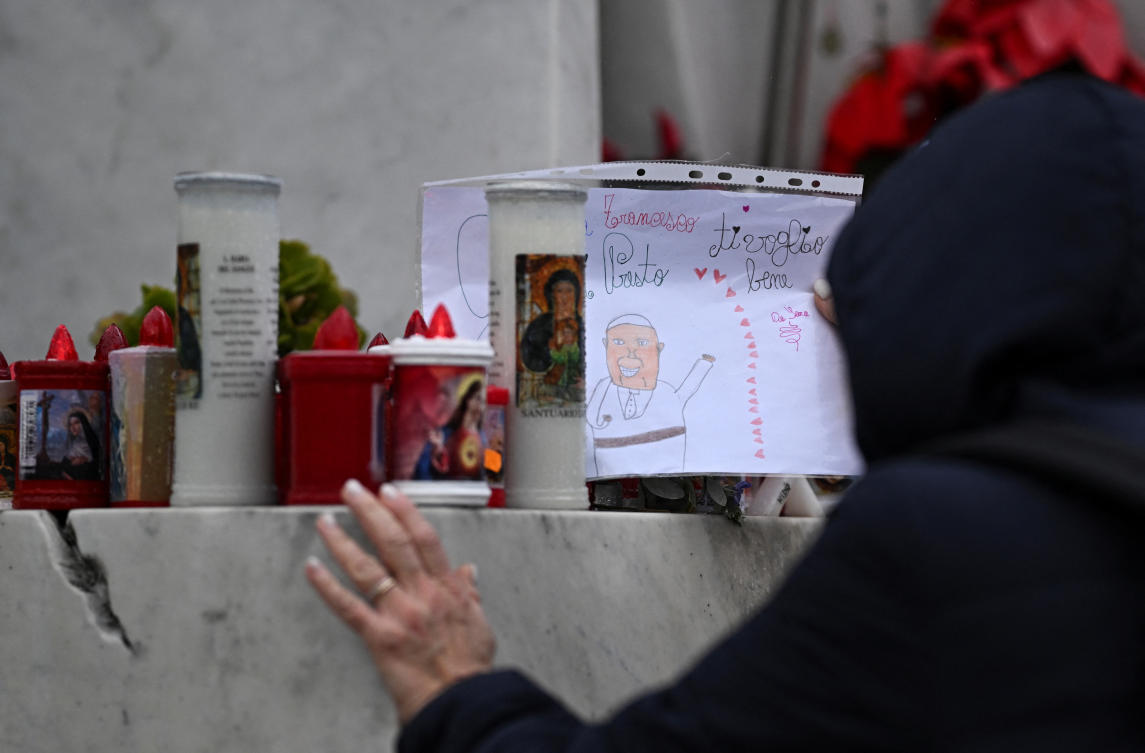 A person places a drawing of Pope Francis at the base of the statue of late Pope John Paul II outside Gemelli Hospital, where Pope Francis continues his treatment, in Rome, Italy, February 25, 2025. (Reuters)
