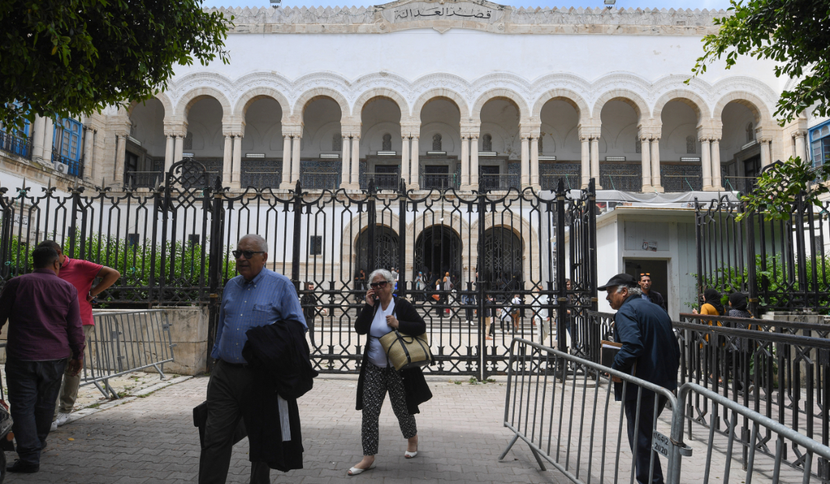 People walk in front of the Tunis Court on May 13, 2024, as the Tunisian bar association declares a strike and boycott of hearings to protest security forces storming its premises to make arrests a couple of days earlier. (AFP)