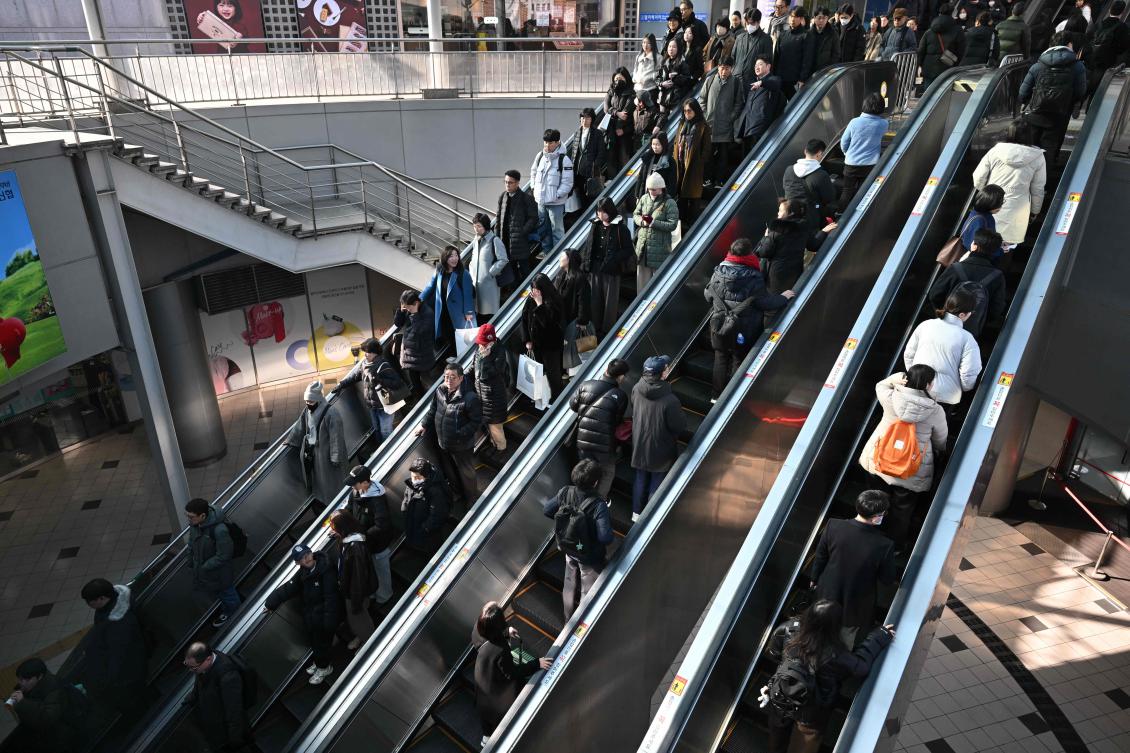 People use escalators outside a train station in Seoul on February 26, 2025. South Korea’s birth rate rose last year for the first time in almost a decade, official data showed on February 26, 2025 bucking a trend in a country battling a demographic crisis. (AFP)