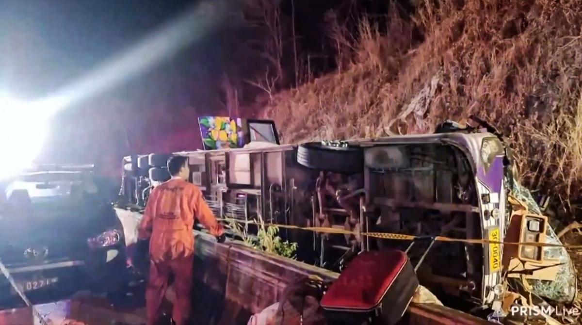 This frame grab taken from video footage provided by local Facebook group 'Sue Prachinburi' on February 26, 2025 via AFPTV shows a rescue worker at the site of a bus crash that killed 18 people in Prachinburi province, east of Bangkok. (AFP)
