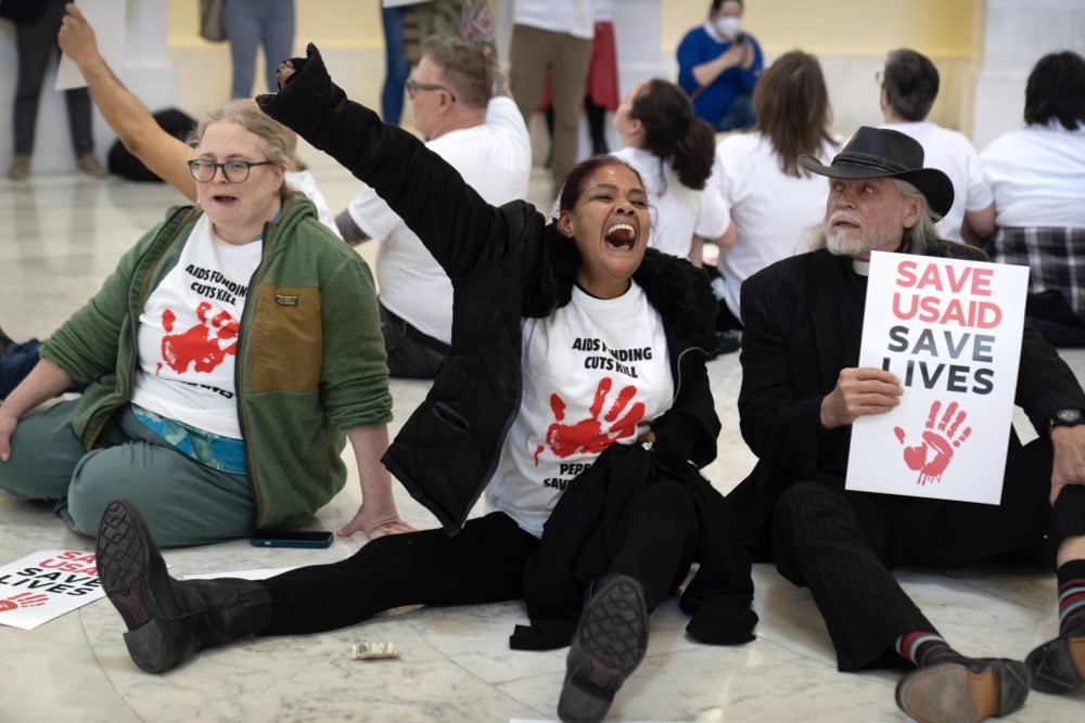 Demonstrators protest against cuts to American foreign aid spending. (AP)