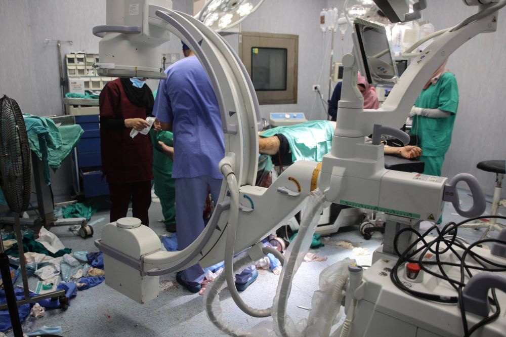 Doctors at the Indonesian Hospital in Beit Lahia in the northern Gaza Strip perform surgery on a victim of Israeli bombardment, on July 9, 2024. (AFP)