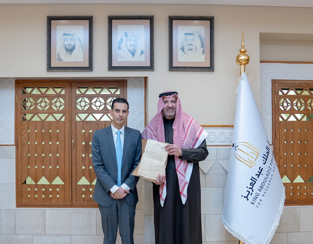 Indian Nadir Akram delivers recently Prince Faisal bin Salman chairman of the board of directors of Darah a letter sent in 1925 to his great grandfather Ghulam Rasul Meher from King Abdulaziz, the founder of Third Saudi State. (Supplied/Darah)