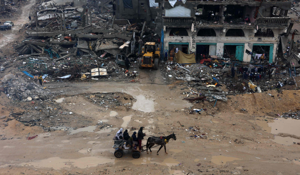 Palestinians ride a horse cart amid the devastation in Beit Hanun in the northern Gaza Strip on February 12, 2025. (AP)
