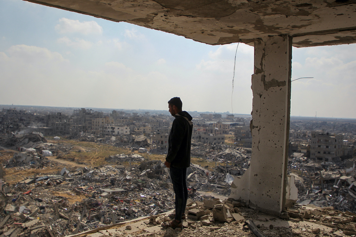 A Palestinian man views the rubble of buildings destroyed during the 15-month Israeli offensive. (Reuters)