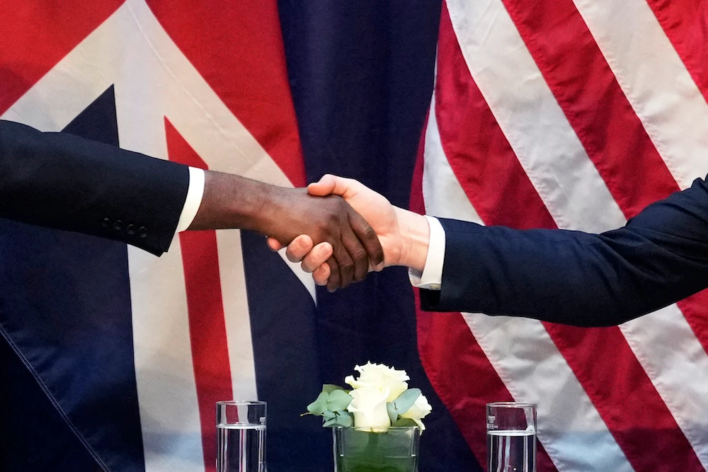 US Vice-President JD Vance, right, and UK’s top envoy David Lammy shake hands on the sidelines of the Munich event. (AP)