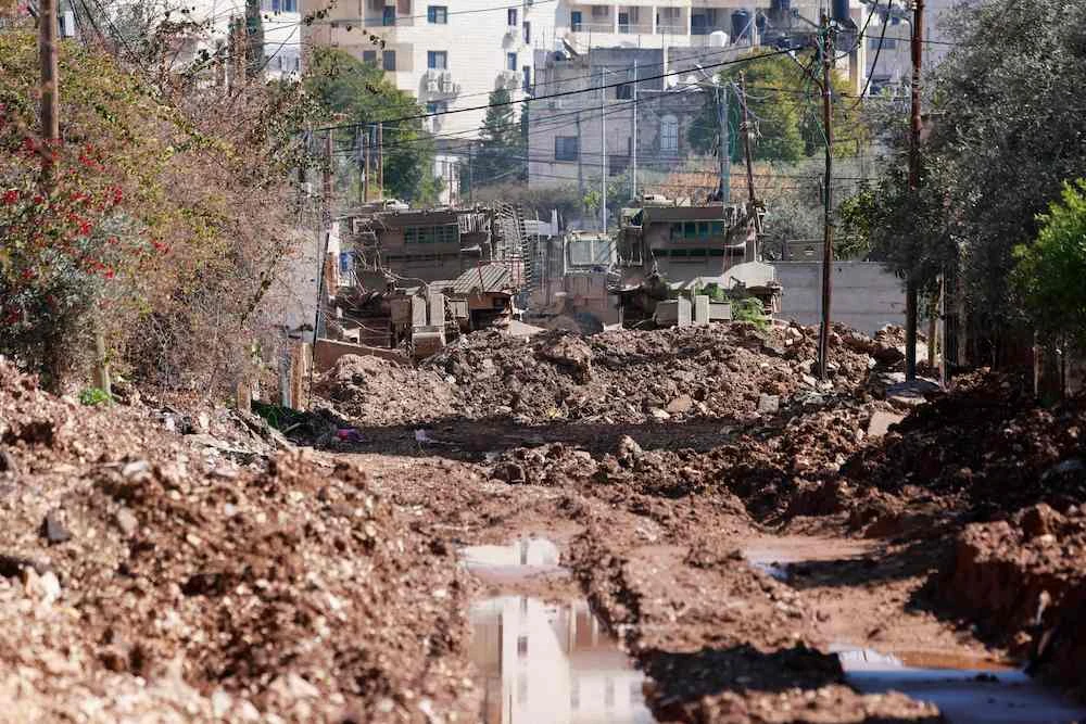 Israeli military bulldozers destroy a road in the occupied West Bank on Feb. 25, 2025. (AFP)