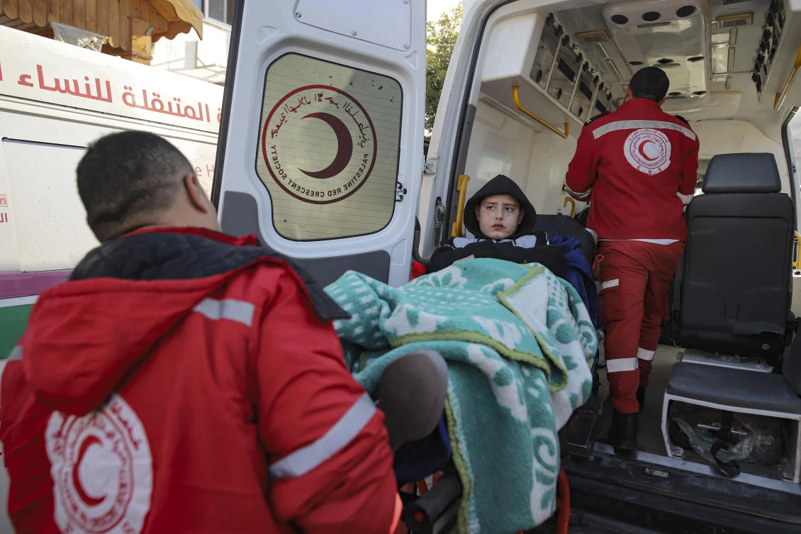 A Palestinian girl wounded in the Israeli bombardment of the Gaza Strip is carried by medics before crossing the Rafah border into Egypt on Feb. 1, 2025. (AP)