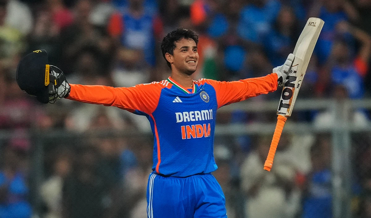 India’s Abhishek Sharma raises his bat as he celebrates after scoring a century during the fifth Twenty20 cricket match against England at Wankhede Stadium in Mumbai, India, on February 2, 2025. (AP)