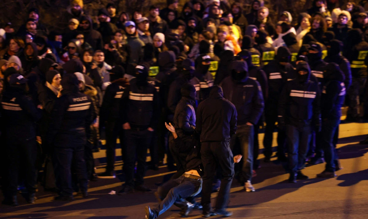 Georgian police detain a protester as anti-government demonstrators attempt to block a highway entrance to the capital Tbilisi on February 2, 2025. The Black Sea nation has been rocked by protests since the Georgian Dream party claimed victory in October parliamentary elections rejected as falsified by the opposition, and then suspended EU accession talks. (AFP)