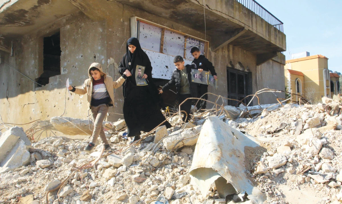 People check the rubble of buildings hit by Israeli bombing in the southern Lebanese border town of Aitaroun as inhabitants return home. (AFP)