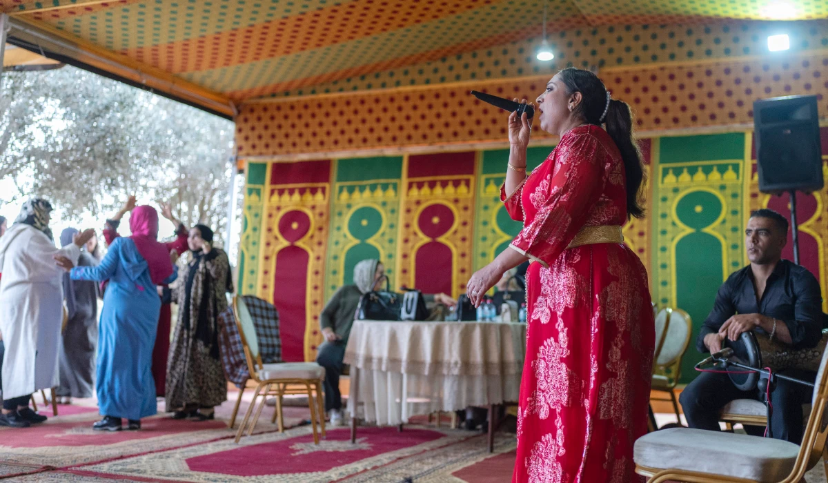 Women dance as folksinger Cheikha Thouria Moullablad gives a traditional performance known as Aita, in Tamesna, south of the capital Rabat, Morocco, Monday, Jan. 27, 2025. (AP)