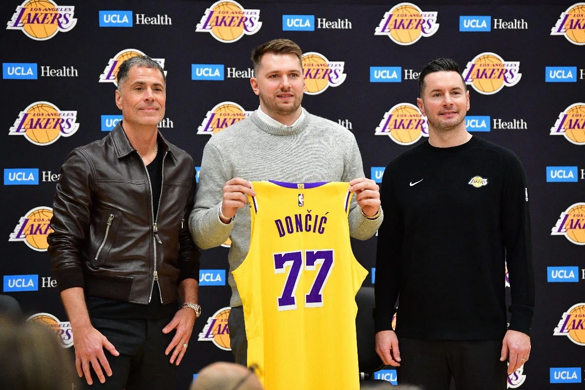 Los Angeles Lakers guard Luka Doncic poses for photos with general manager Rob Pelinka and head coach JJ Redick during a press conference at UCLA Health Training Center Tuesda. (USA TODAY Sports)