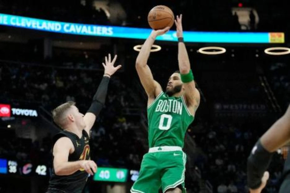 Boston Celtics forward Jayson Tatum shoots over Cleveland Cavaliers guard Sam Merrill in the second half of an NBA basketball game Tuesday in Cleveland. (AP)