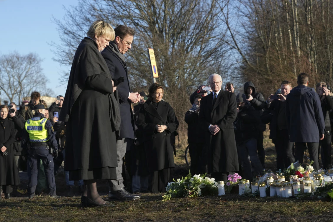 Sweden’s Prime Minister Ulf Kristersson and his wife Birgitta Ed place flowers at a memorial near the scene of a shooting on the outskirts of Orebro, Sweden, Feb. 5, 2025. (AP)