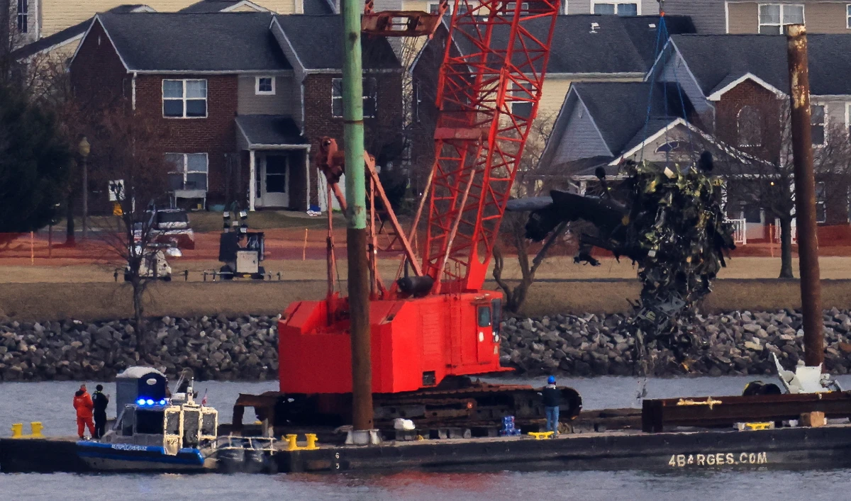 A crane retrieves part of the helicopter from the Potomac River, in the aftermath of the collision of American Eagle flight 5342 and a Black Hawk helicopter that crashed into the river, by the Ronald Reagan Washington National Airport, in Arlington, Virginia, U.S., February 6, 2025. (Reuters)
