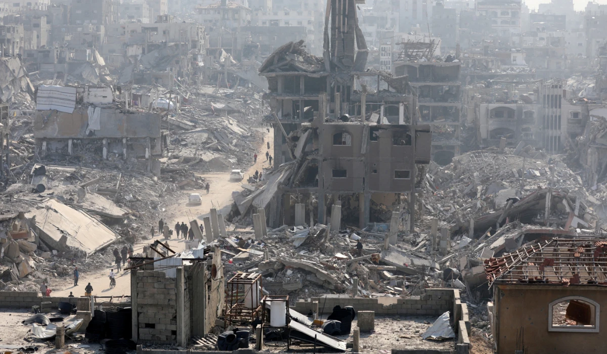 People walk past the rubble of destroyed buildings, in Jabalia, in the northern Gaza Strip, January 30, 2025. (REUTERS)