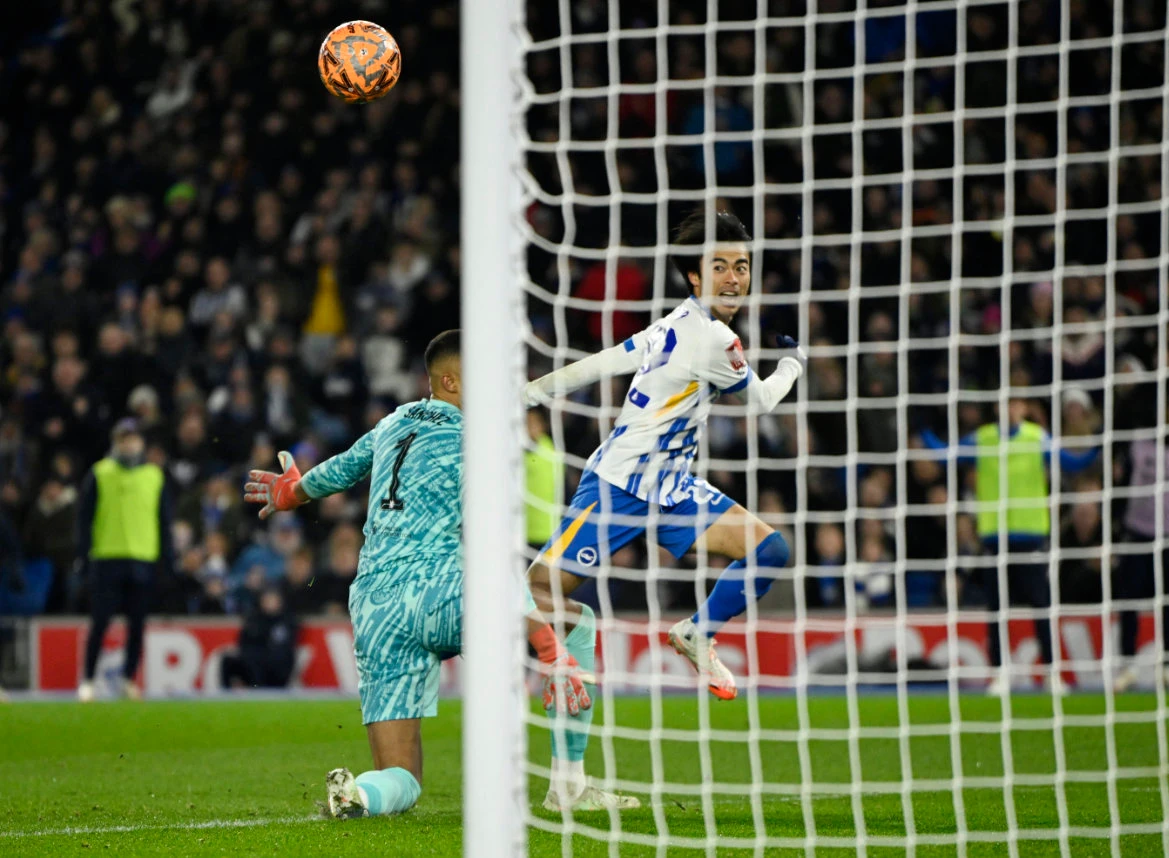 Brighton & Hove Albion’s Kaoru Mitoma scores their second goal past Chelsea’s Robert Sanchez during their FA Cup fourth round at the American Express Community Stadium, Brighton, on Friday. (Reuters)