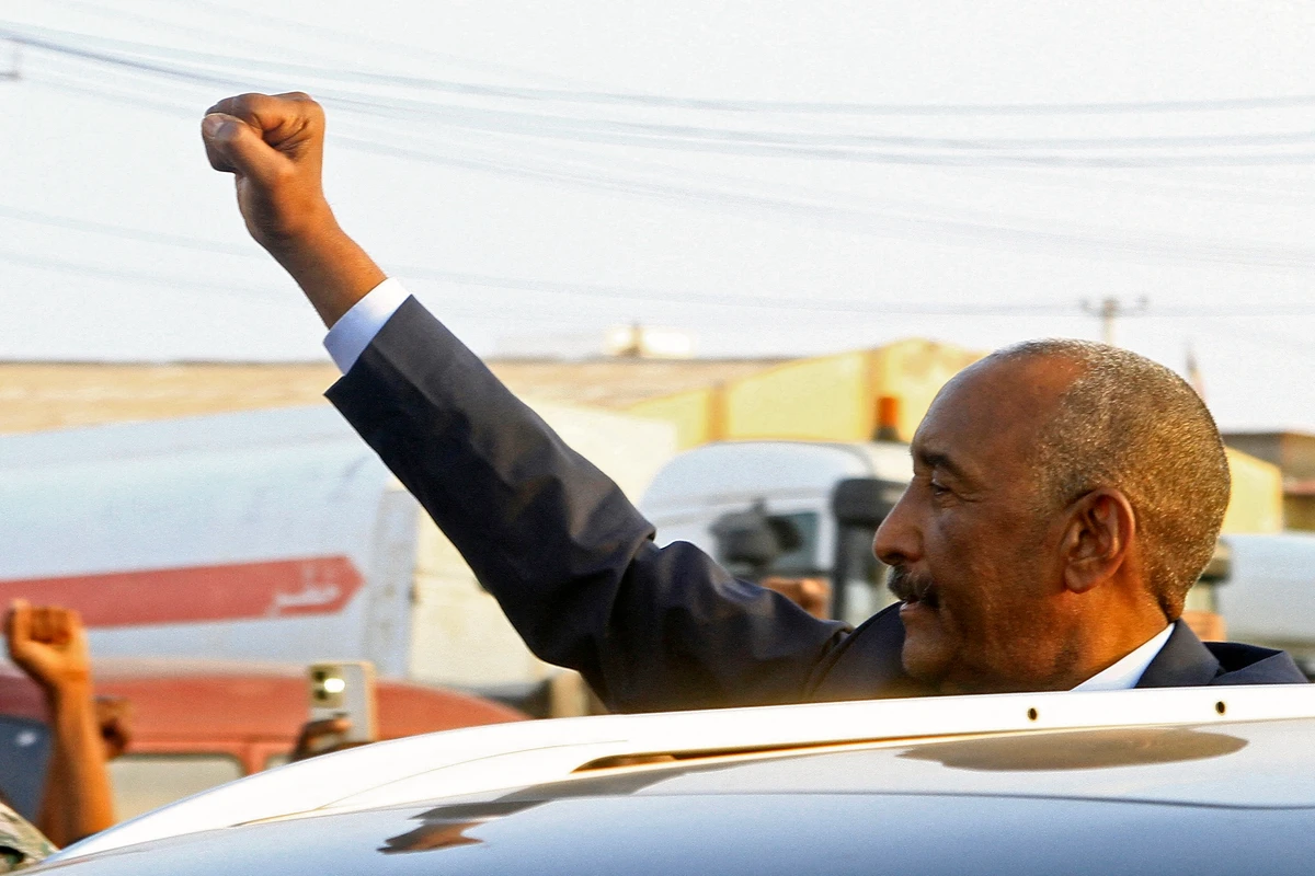 Sudan's army chief Abdel Fattah al-Burhan gestures to people waiting to greet him along a street in Port Sudan, Jan. 14, 2025. (AFP)