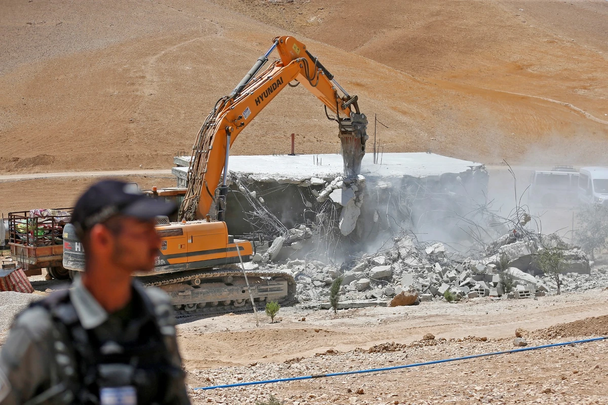 An Israeli bulldozer demolishes a Palestinian house in the Umm Qasas area of Masafer Yatta in the occupied West Bank, July 25, 2022. (AFP)